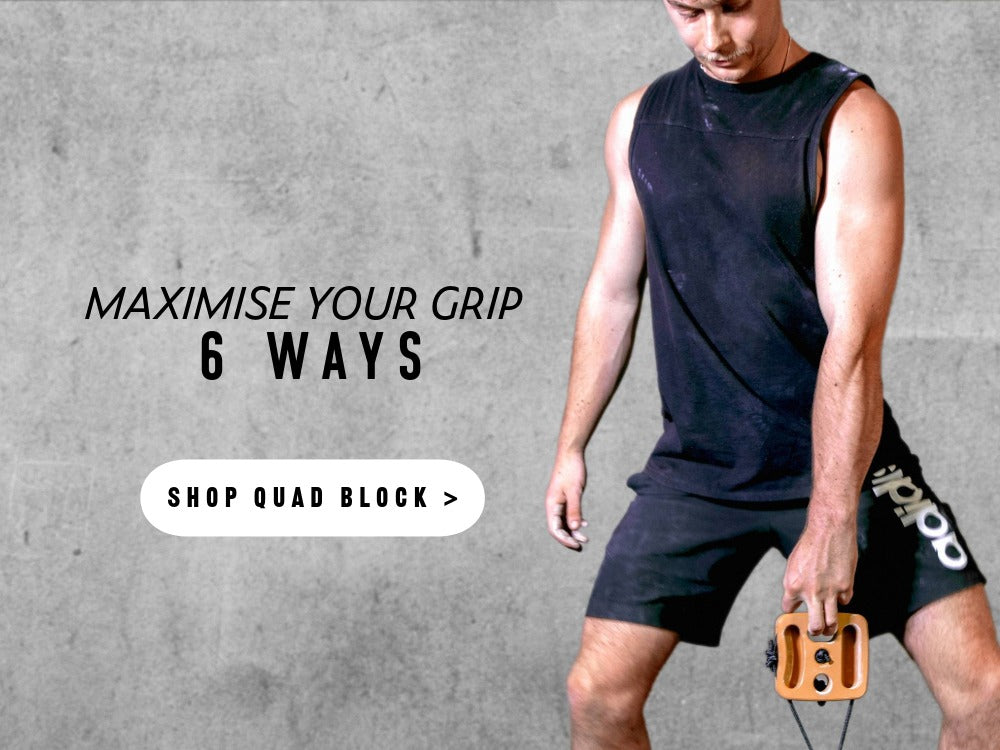 Person strengthening their grip strength for climbing and bouldering with Crux Gear Quad Block.
