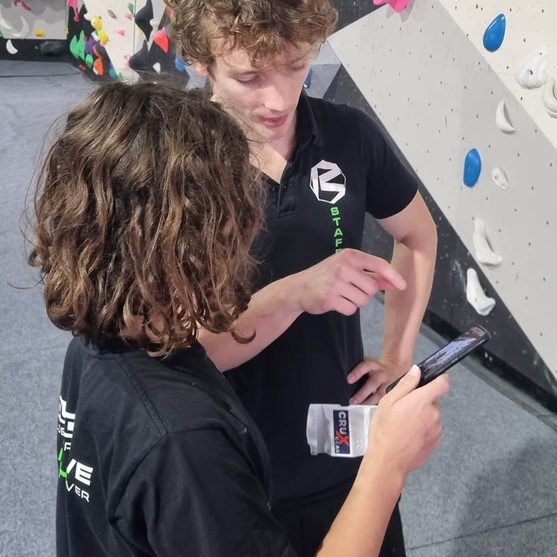 Climbers checking video from a Crux Gear Phone Stone