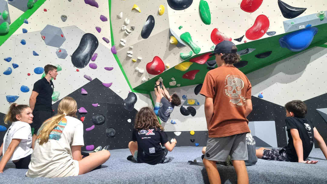 Climbers watching a bouldering wall